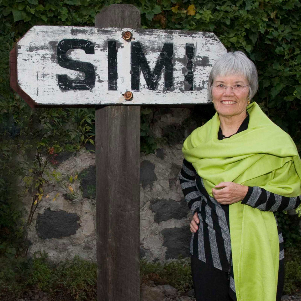 Woman standing in front of SIMI sign.