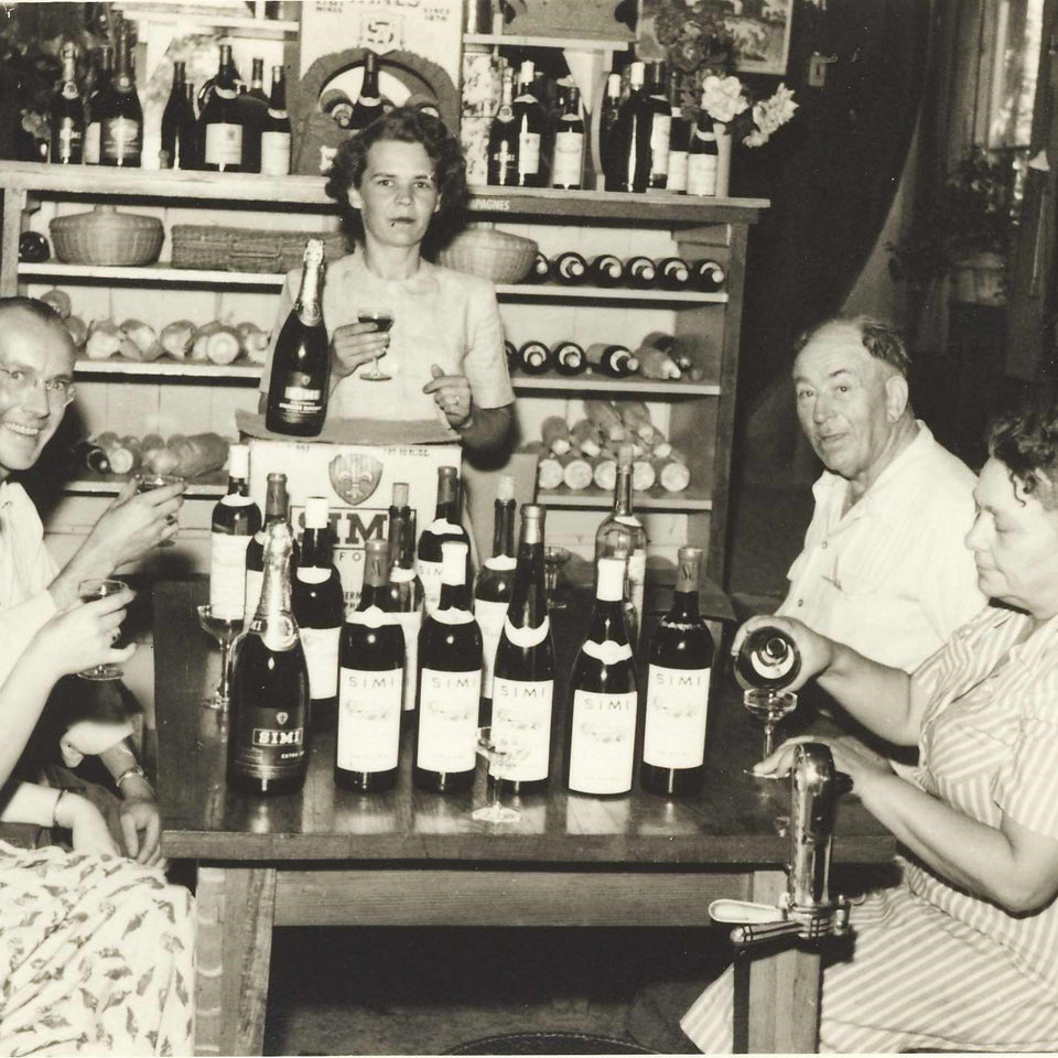 Historic photo of Isabelle Simi pouring wine in black and white.