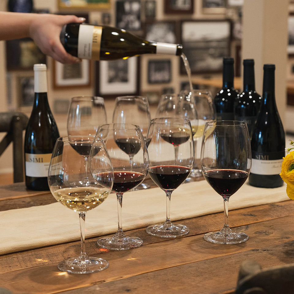 Four wine glasses filled with SIMI wines ready for a guided tasting.
